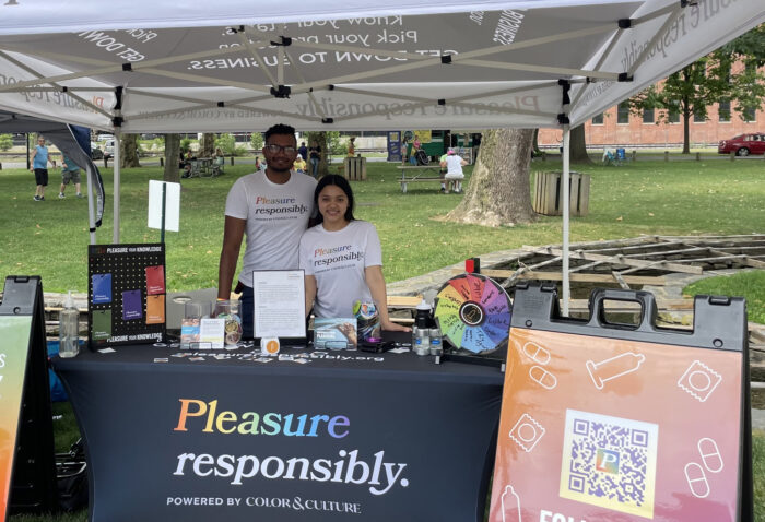 Two staff members at a Pleasure Responsibly booth.